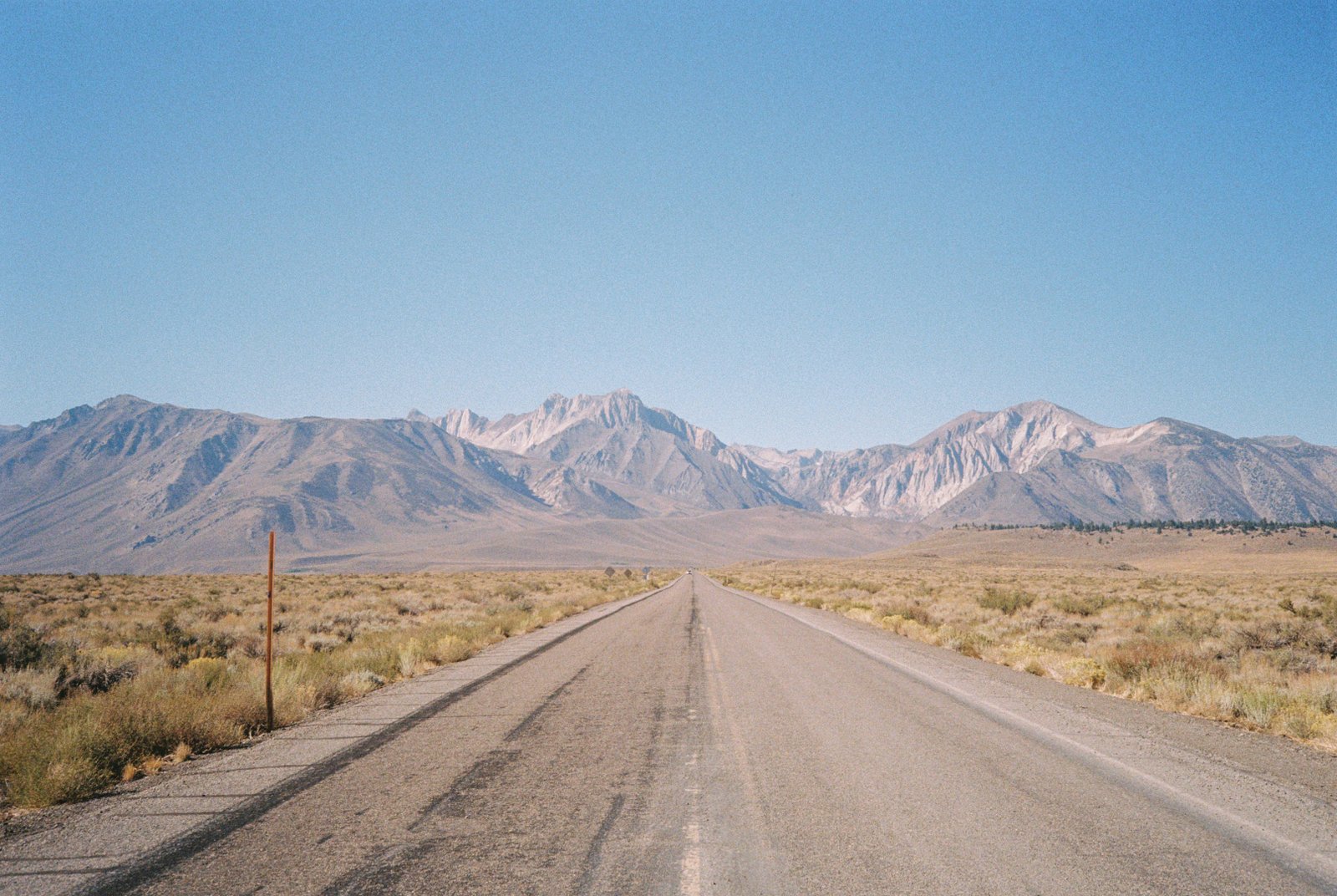 Desert highway stretching toward the Eastern Sierra mountains
