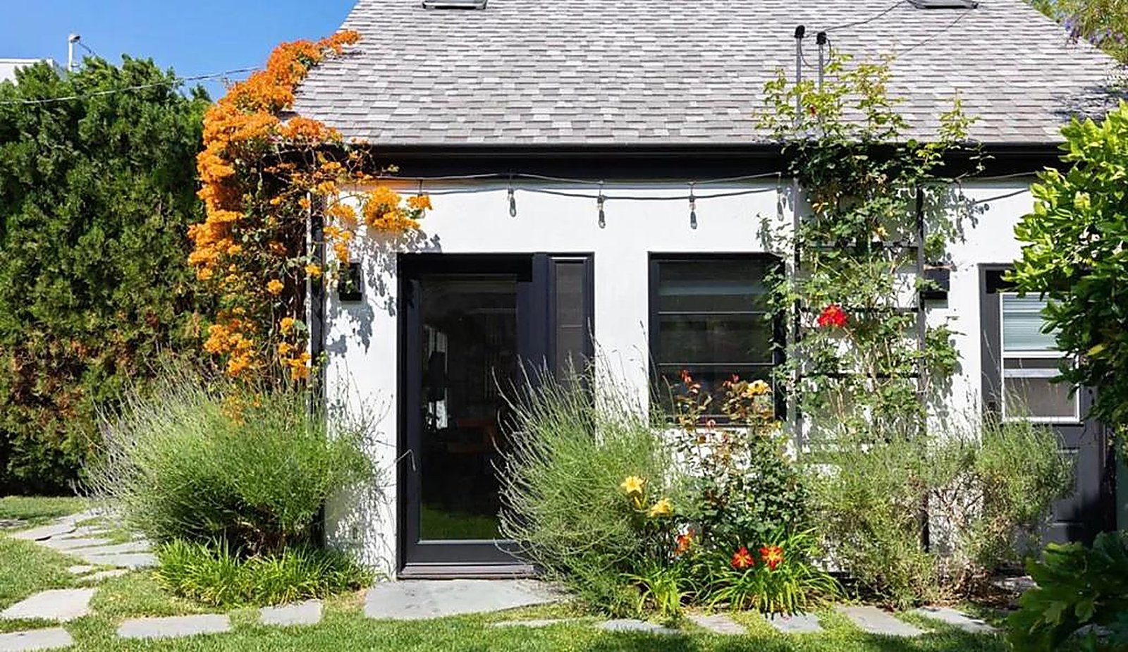 Backyard garden with string lights and flowering plants at Santa Monica rental property