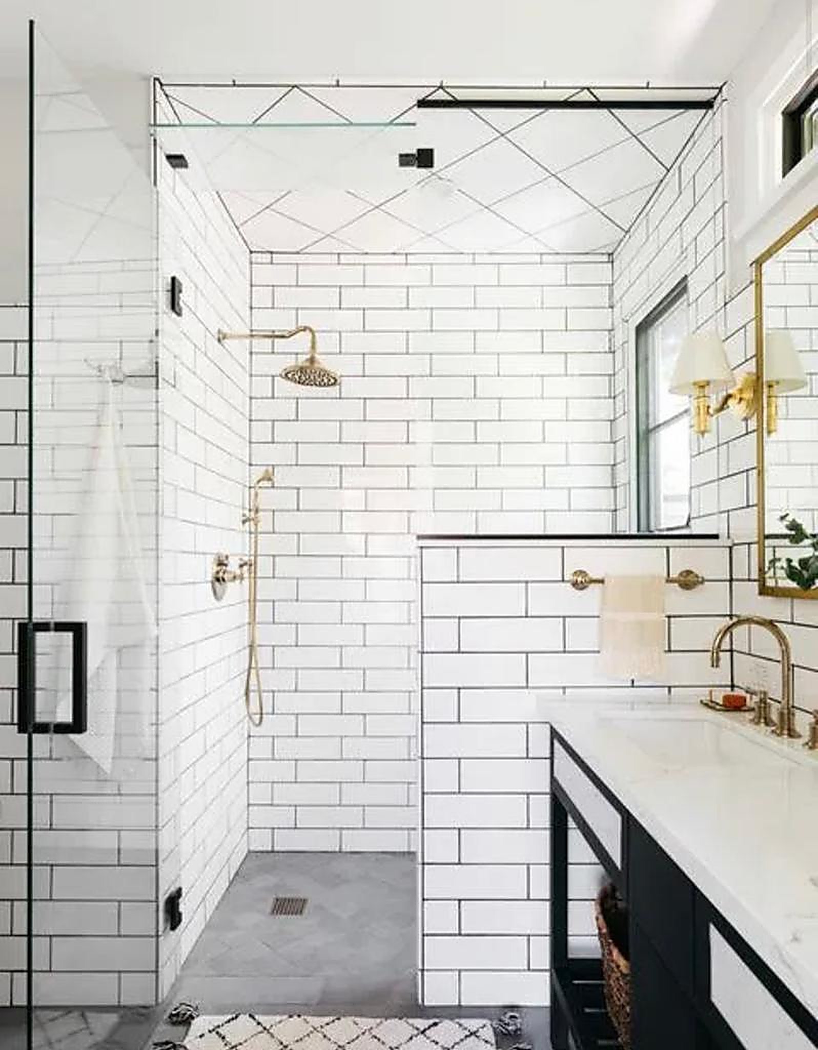 Bathroom with white subway tile and brass fixtures in Santa Monica rental