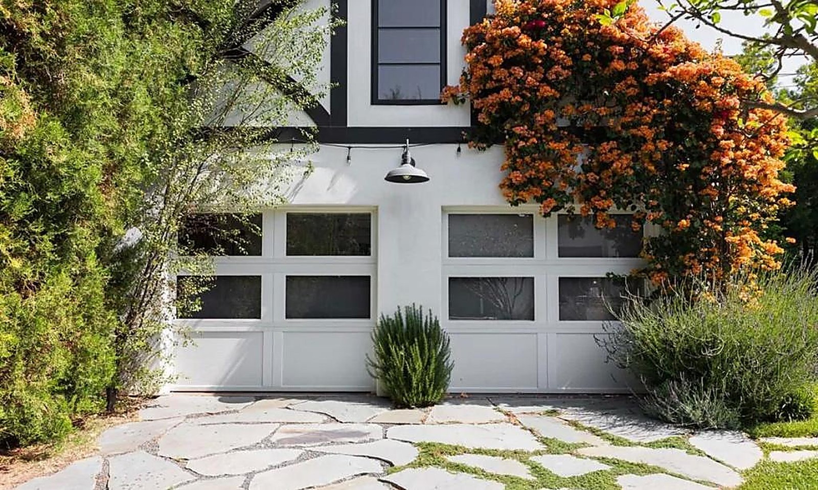 Craftsman-style garage with bougainvillea and flagstone driveway in Santa Monica