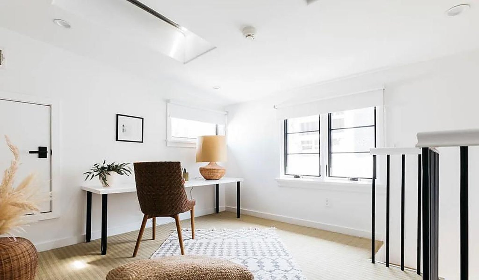 Bright upstairs home office with woven chair and natural light in Santa Monica rental