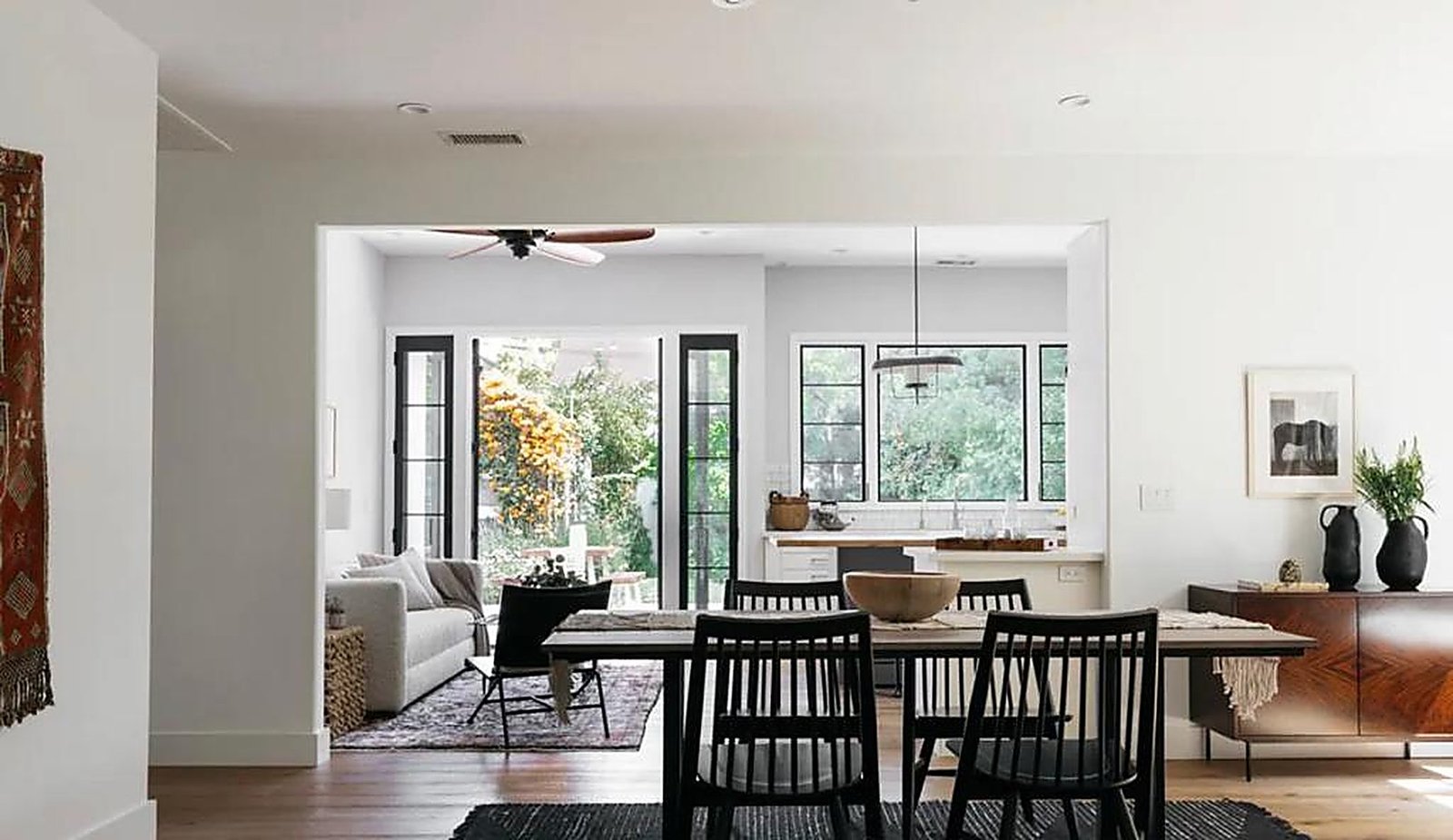 Open-plan living and dining area with hardwood floors and French doors in Santa Monica furnished rental