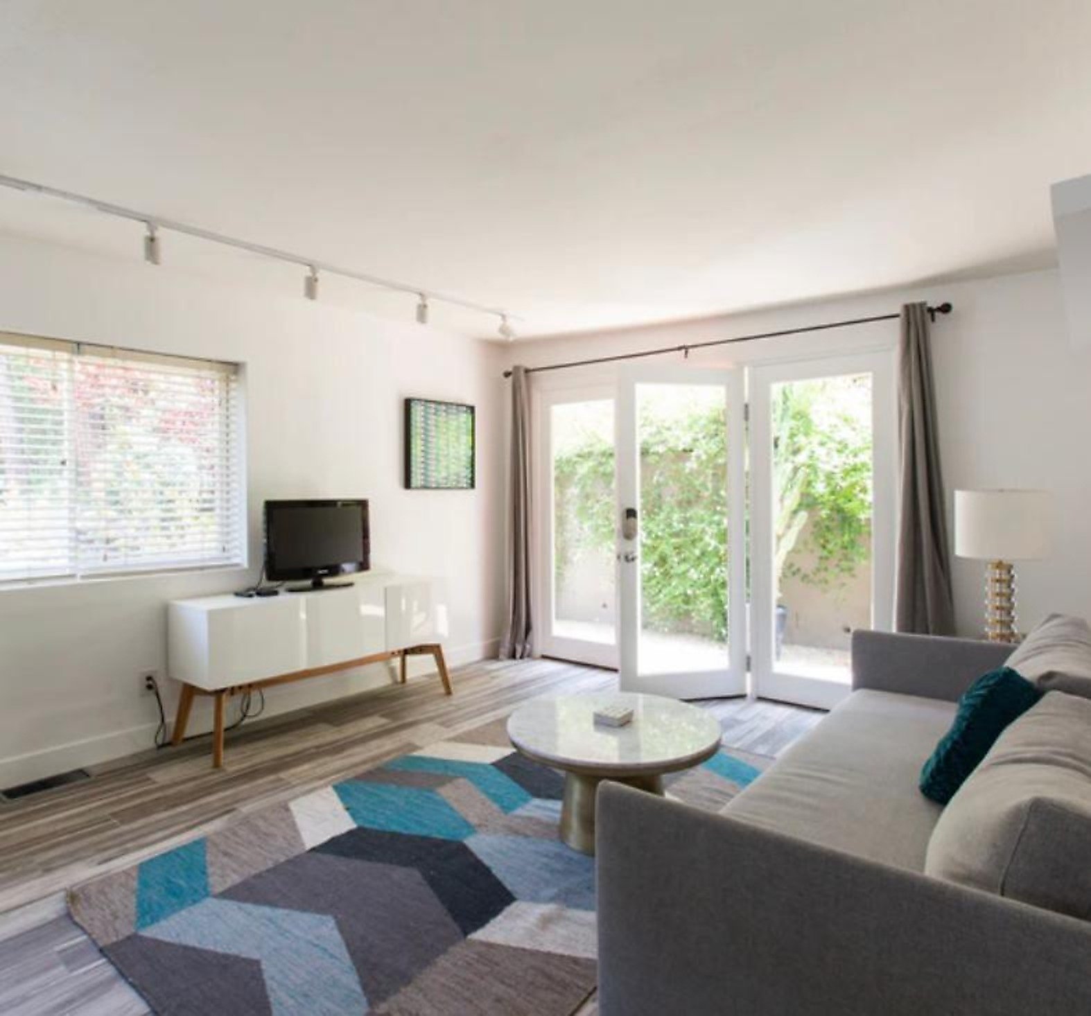 West Hollywood furnished apartment living room with French doors to patio