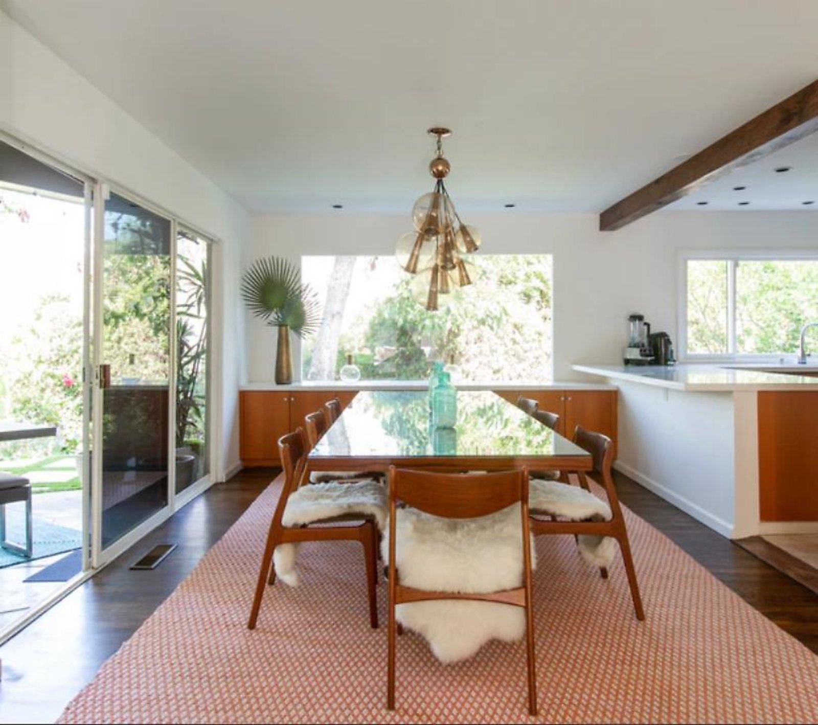 West Hollywood furnished apartment dining room with designer chandelier and garden views