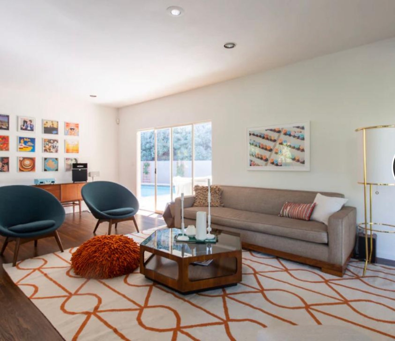 West Hollywood furnished apartment living room with pool view and mid-century chairs